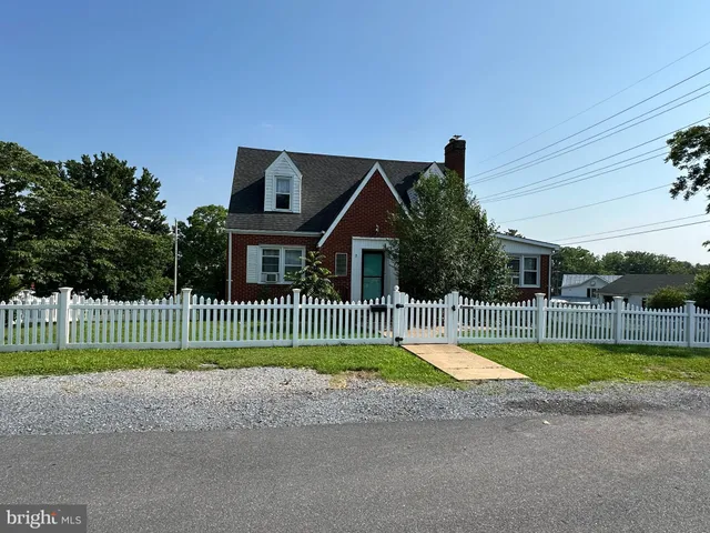 a view of a house with a swimming pool and a yard