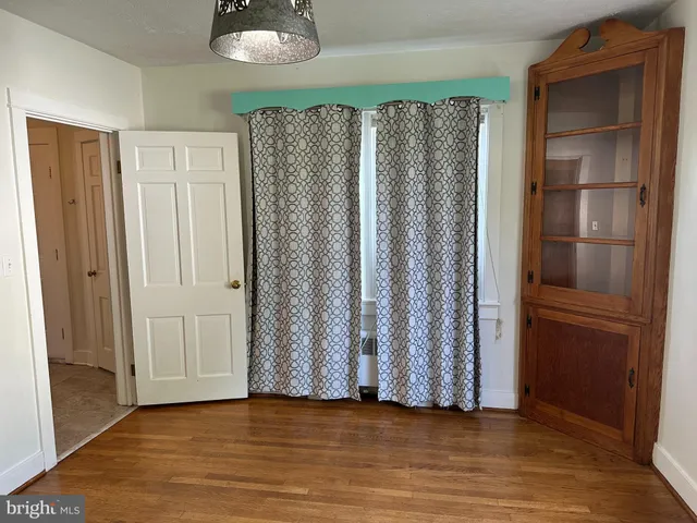 a view of wooden floor and closet in a room