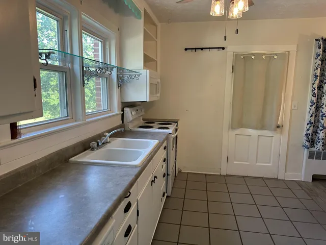 a bathroom with a sink a vanity and a mirror