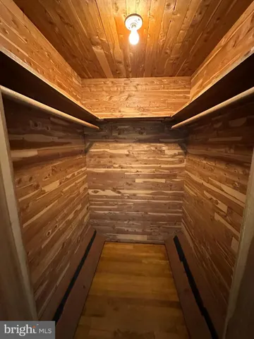 a view of a room with wooden floor staircase and a kitchen space