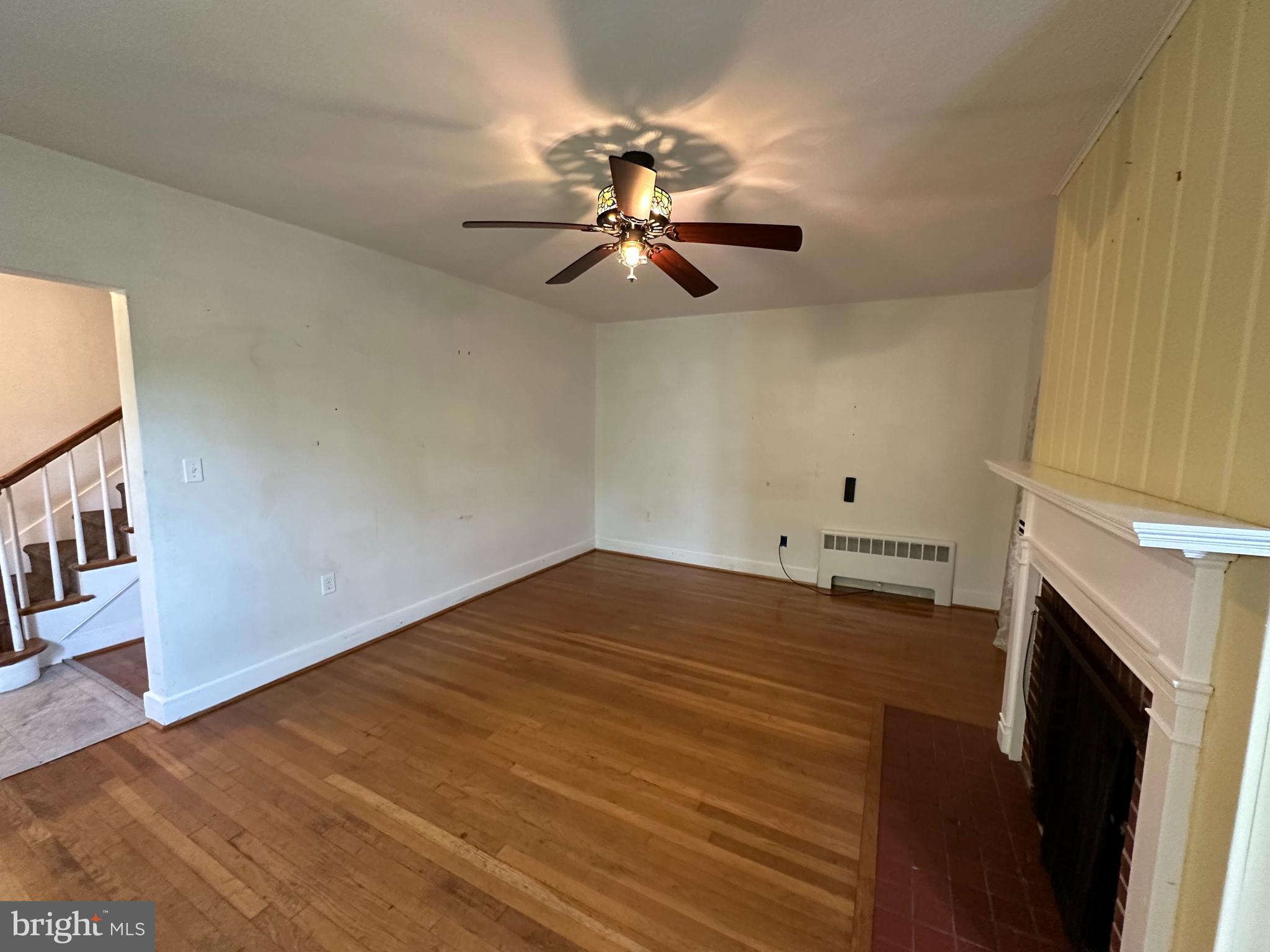 2 Terrace Lane Luray, VA 22835 - Photo 6 of 35 a view of a room with wooden floor fireplace and a ceiling fan