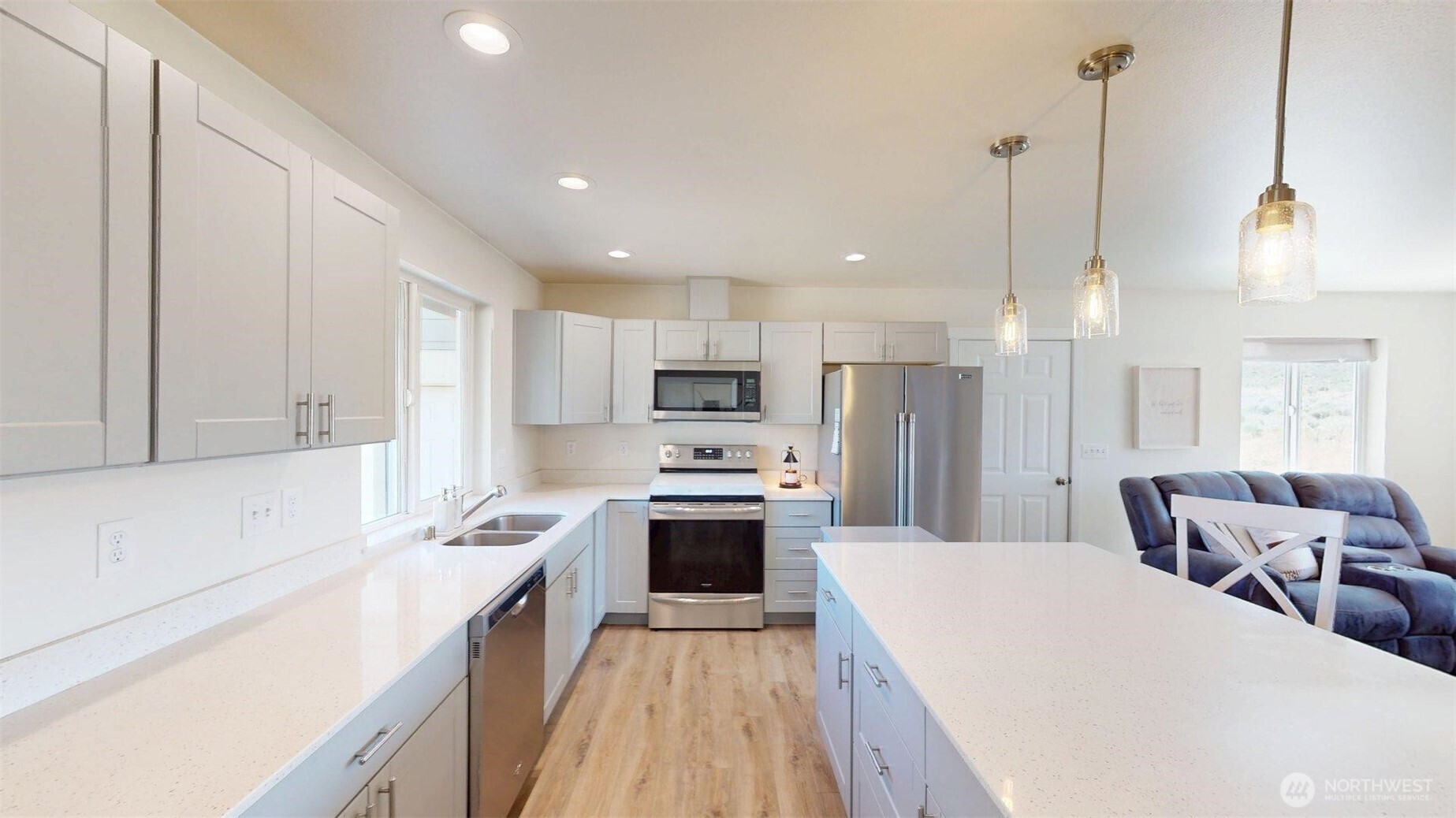 212 Hubbard Road Riverside, WA 98849 - Photo 11 of 39 a kitchen with stainless steel appliances kitchen island a stove a sink a refrigerator a center island with a oven and cabinets