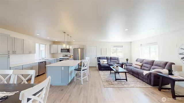 a living room with lots of furniture and kitchen view