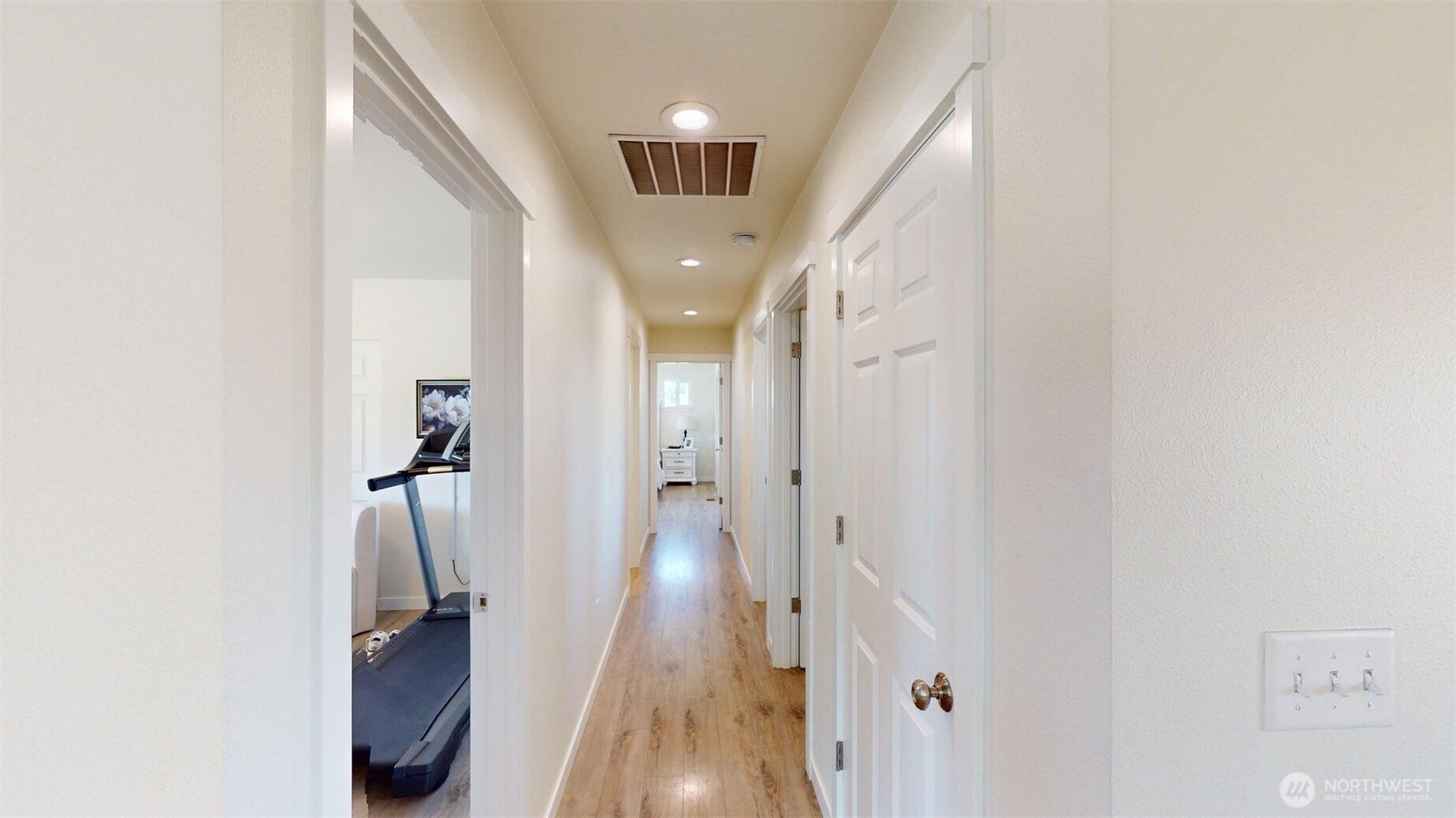 212 Hubbard Road Riverside, WA 98849 - Photo 15 of 39 a view of a hallway with a white door and wooden floor
