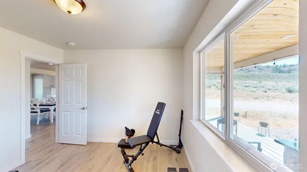 a view of a workspace with furniture and wooden floor