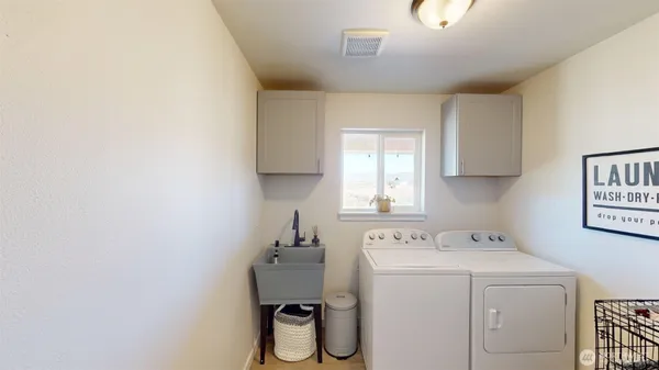 a utility room with a sink dryer and washer