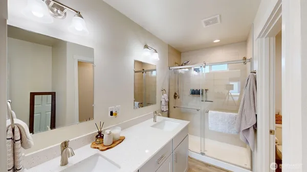 a bathroom with a granite countertop sink mirror and double