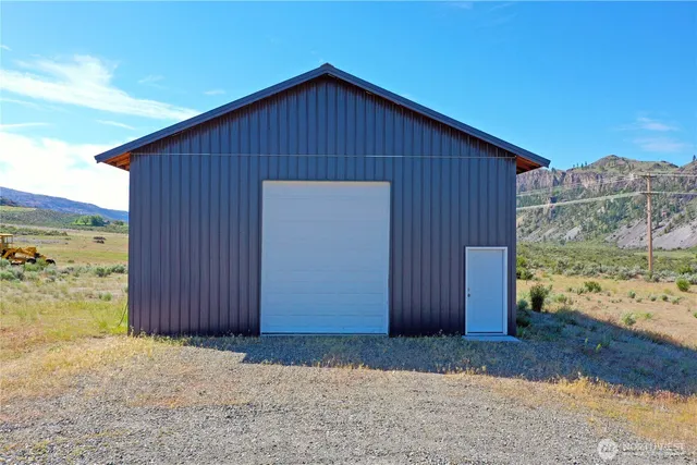 a view of a backyard with wooden fence
