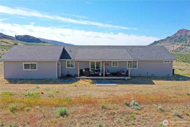 a view of a house with a yard covered in snow