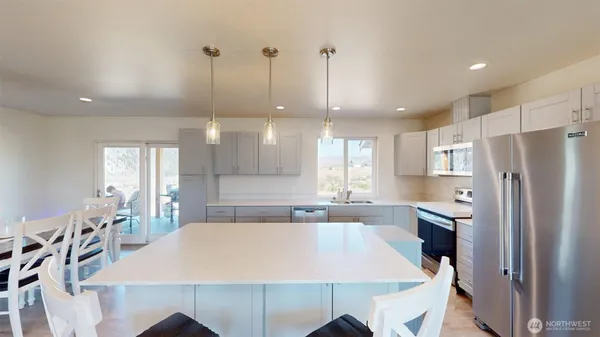 a large kitchen with a table and chairs
