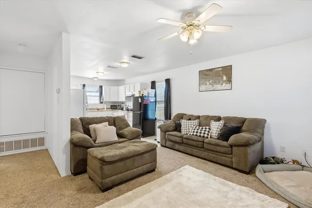 a living room with furniture and a chandelier