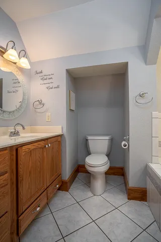 a bathroom with a toilet sink and mirror