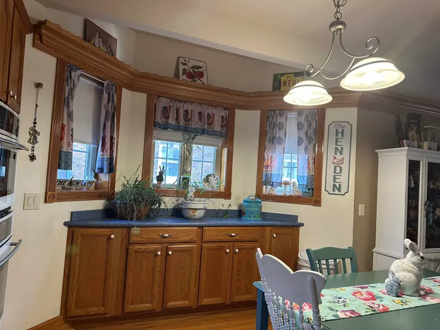 a view of a dining room with furniture and a chandelier