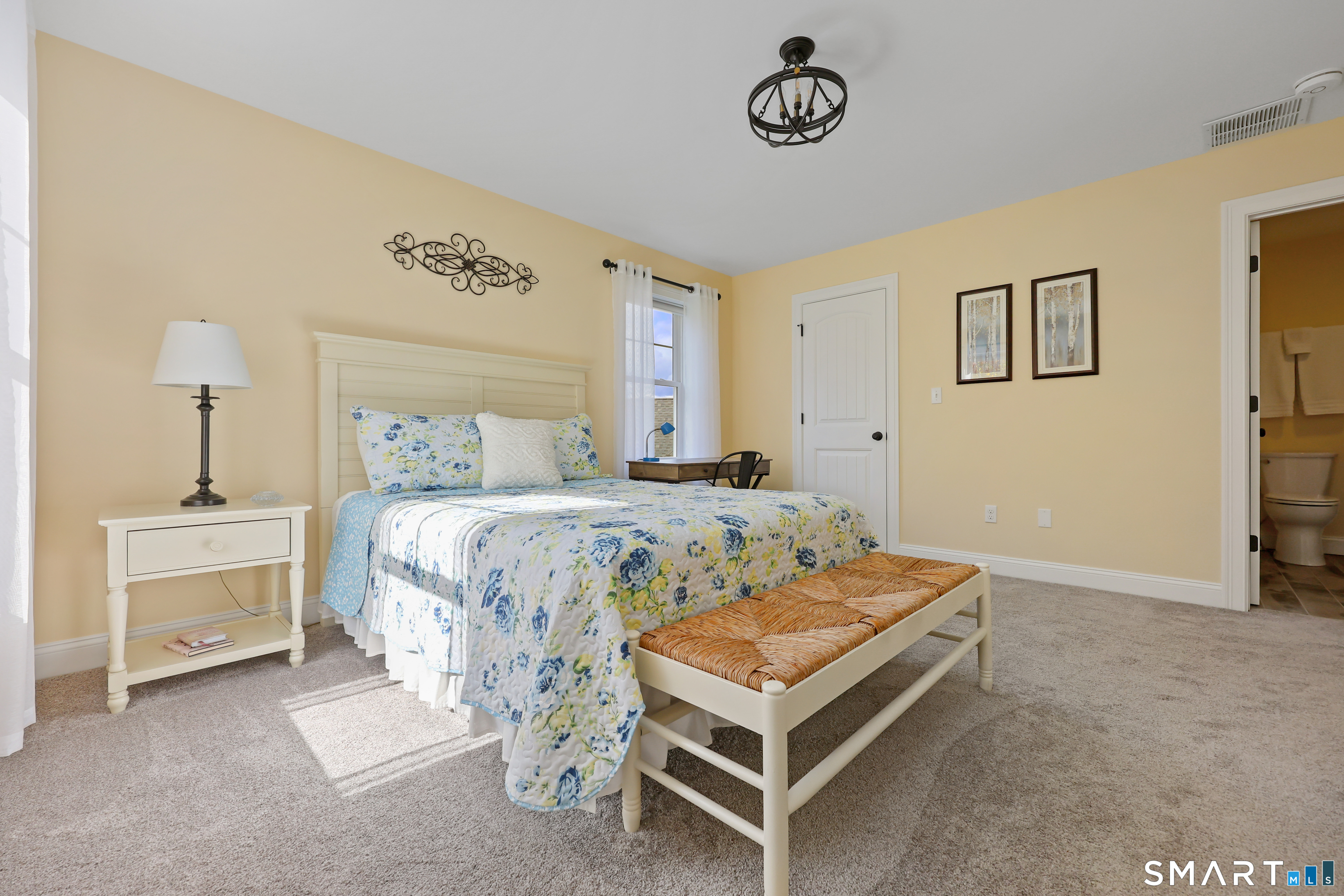 20 Lakeview Estates, Unit 20 Middlefield, CT 06455 - Photo 27 of 36 a bedroom with a bed and a table