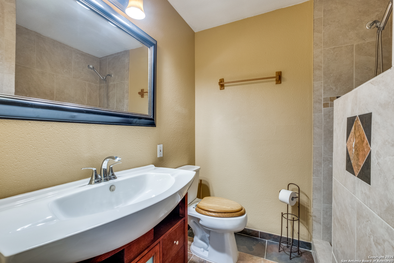 6106 Vance Jackson Road, Unit 46 San Antonio, TX 78230 - Photo 17 of 25 a bathroom with a sink a toilet and mirror