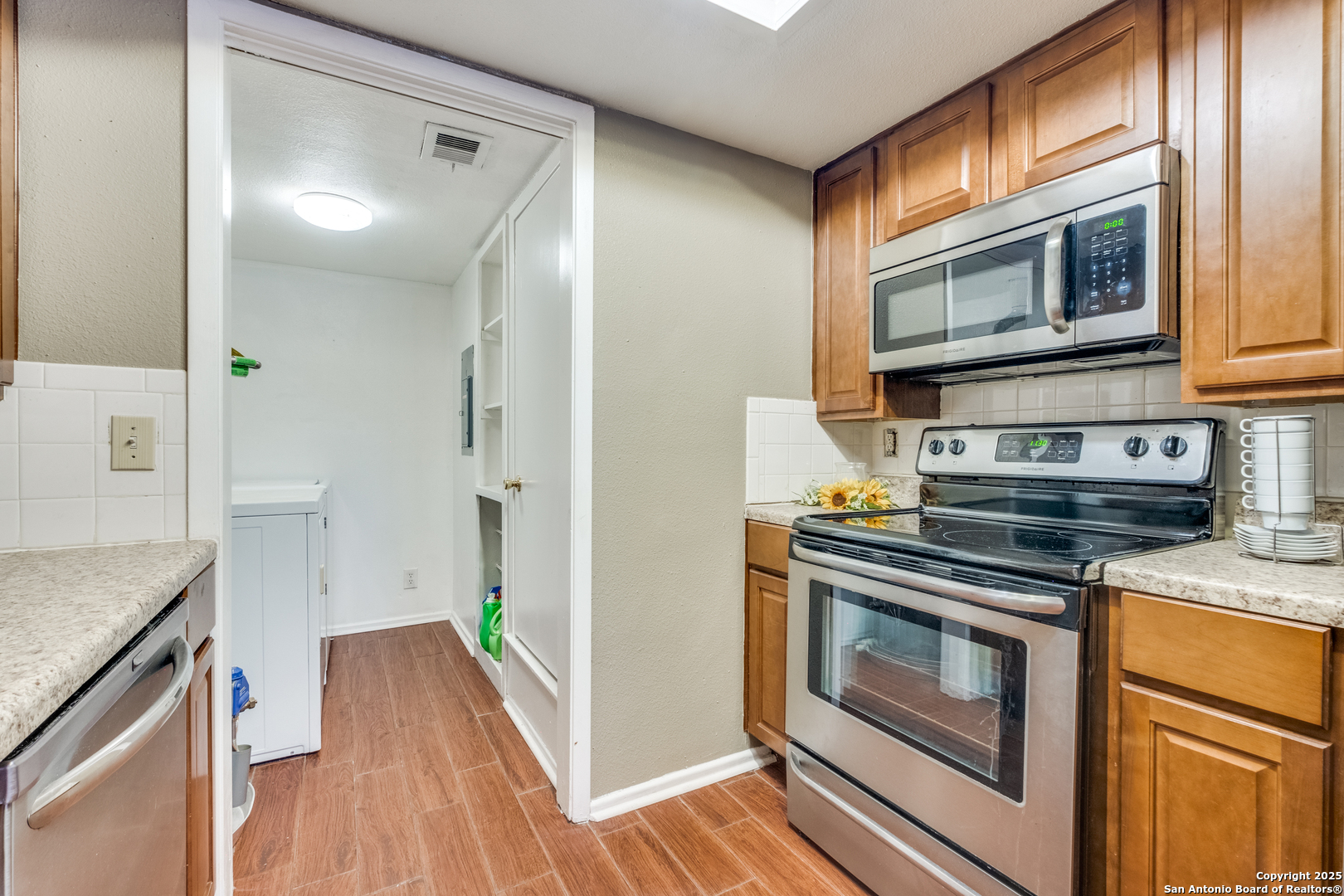 6106 Vance Jackson Road, Unit 46 San Antonio, TX 78230 - Photo 9 of 25 a kitchen with a stove oven and a sink
