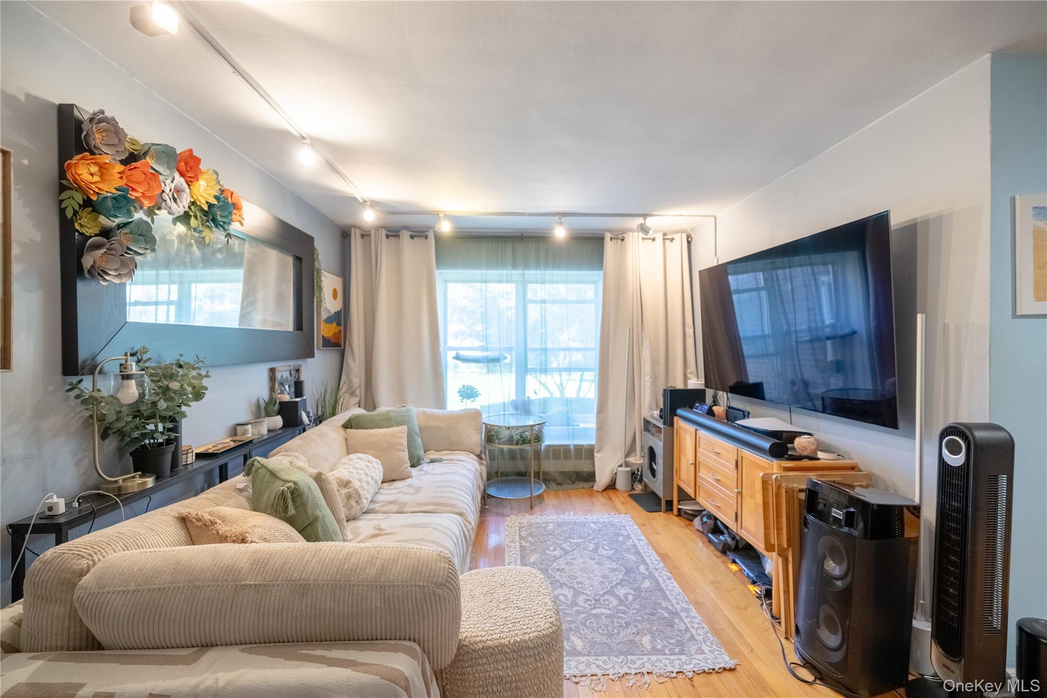 221 Middle Neck Road, Unit M2 Great Neck, NY 11021 - Photo 1 of 1 Living area featuring light wood-type flooring and rail lighting