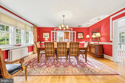 a dining room with furniture a rug and a chandelier
