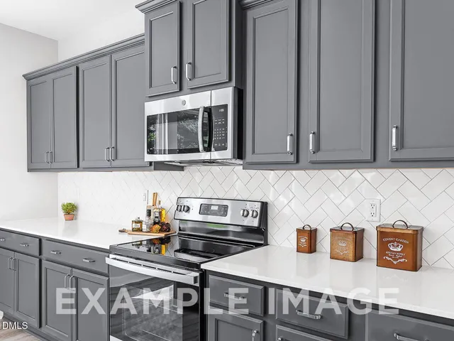 a kitchen with stainless steel appliances granite countertop a stove a microwave and cabinets