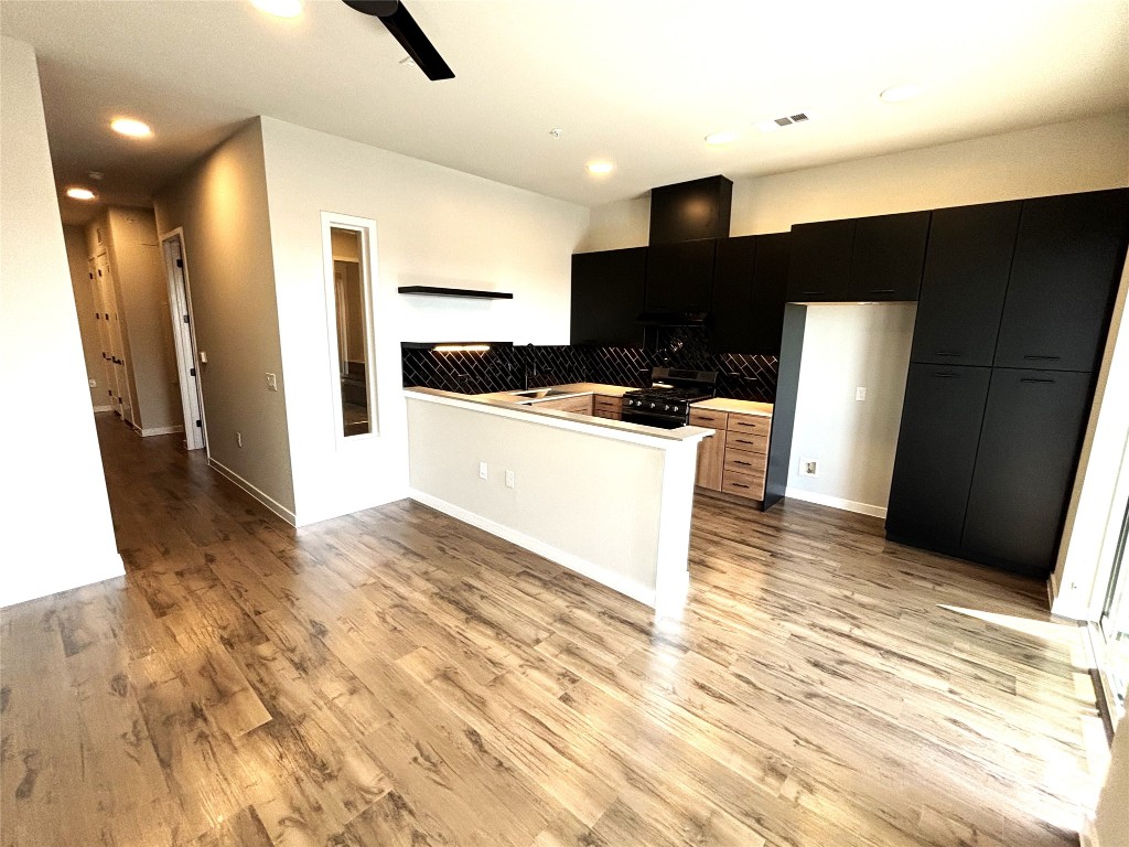 4510 Terry-O Lane, Unit 406 Austin, TX 78745 - Photo 6 of 34 a view of a kitchen with stainless steel appliances a refrigerator and a stove top oven