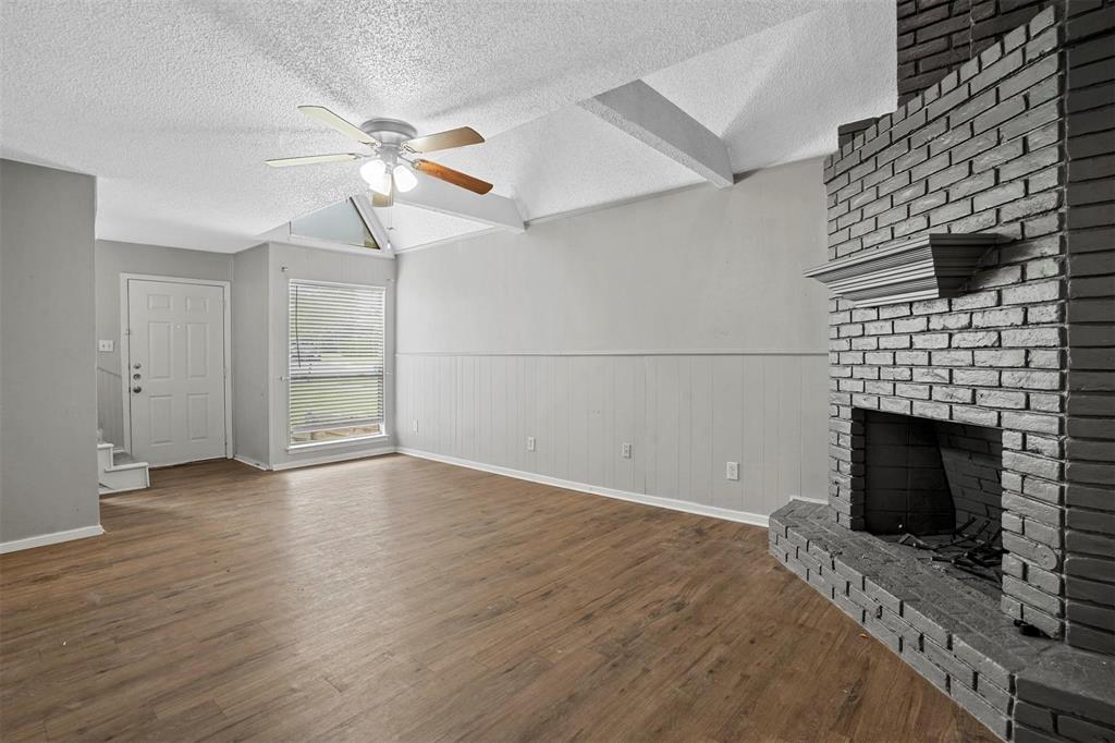 2156 Fleur De Lis Court Arlington, TX 76012 - Photo 3 of 16 a view of empty room with wooden floor and fireplace