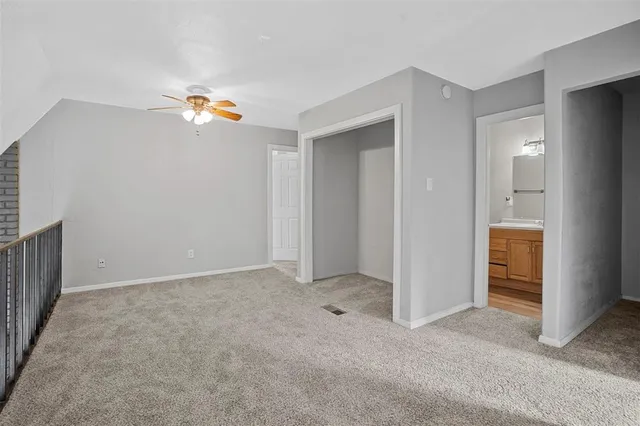 an empty room with a kitchen and a sink