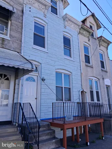 a view of a brick house with a deck