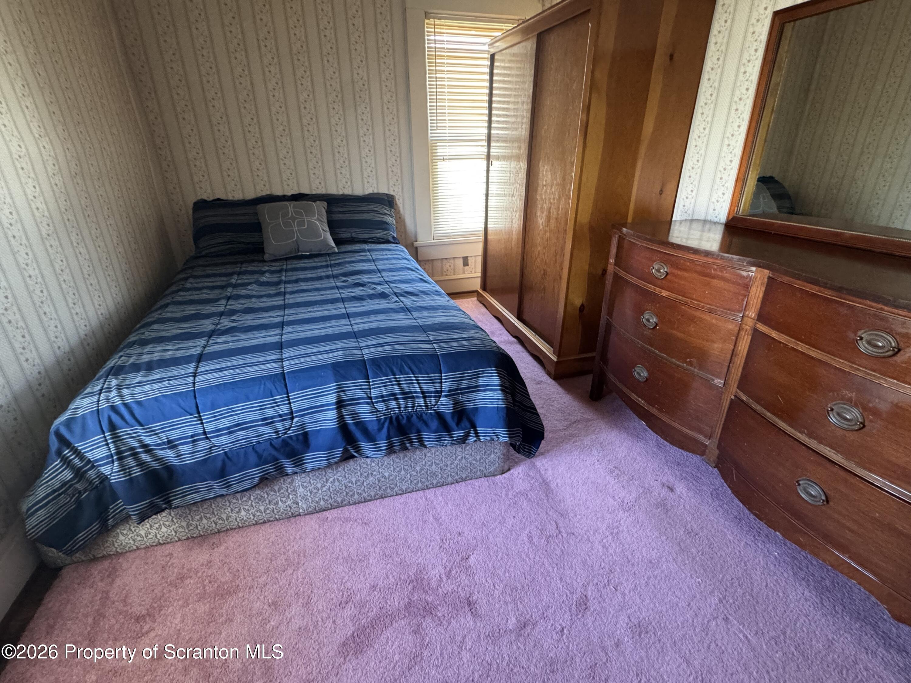 409 East Warren Street Dunmore, PA 18512 - Photo 11 of 19 a bedroom with a bed and a window