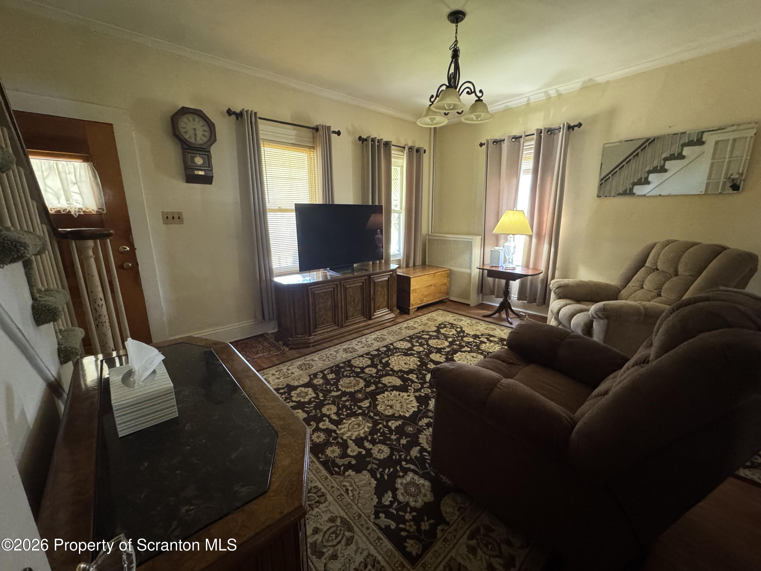 409 East Warren Street Dunmore, PA 18512 - Photo 3 of 19 a living room with furniture and a flat screen tv