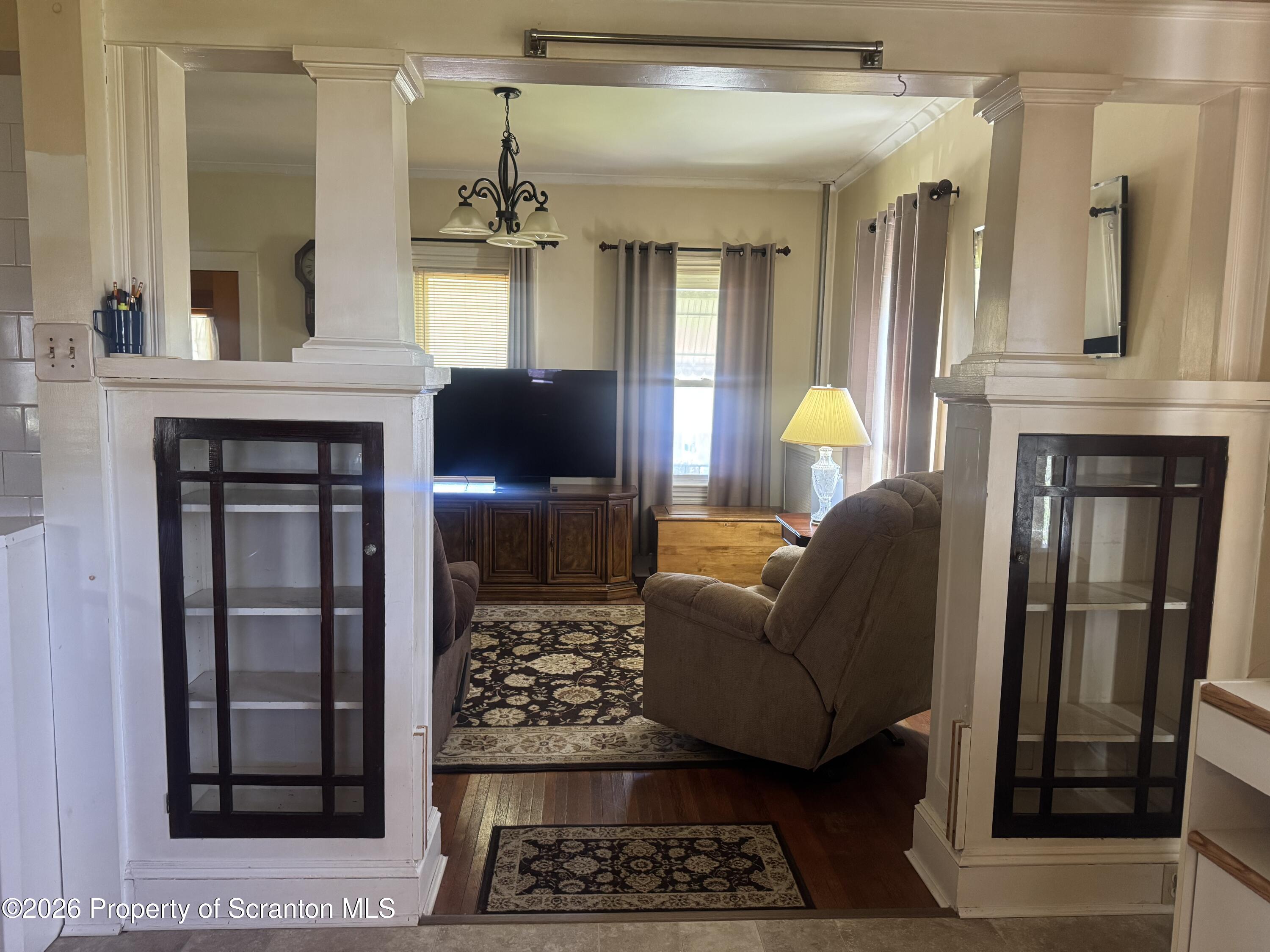 409 East Warren Street Dunmore, PA 18512 - Photo 4 of 19 a living room with furniture a fireplace and a chandelier
