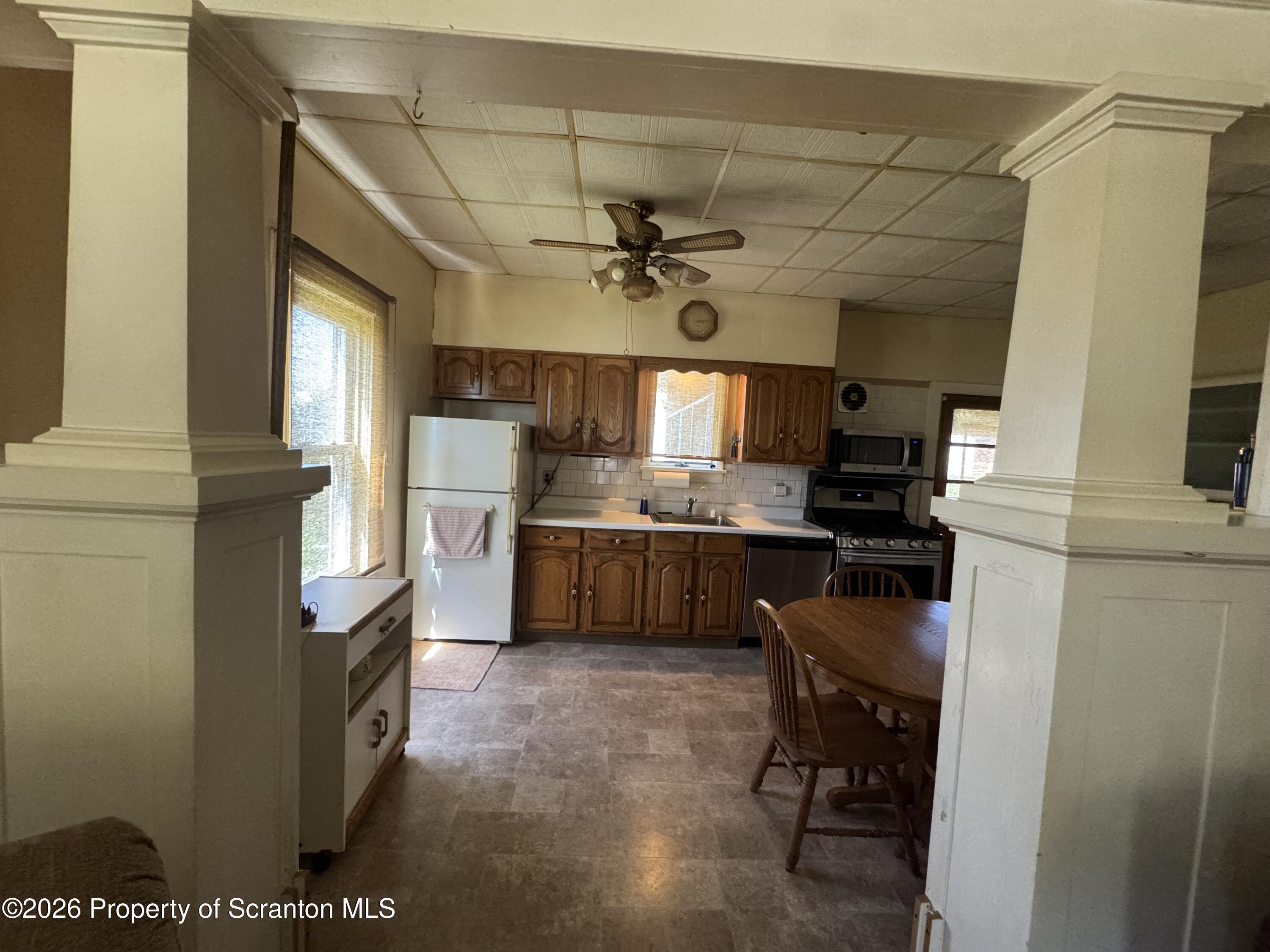 409 East Warren Street Dunmore, PA 18512 - Photo 5 of 19 a kitchen with a sink stainless steel appliances and cabinets