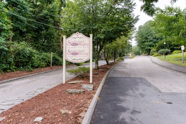 a sign board with a bench in the background