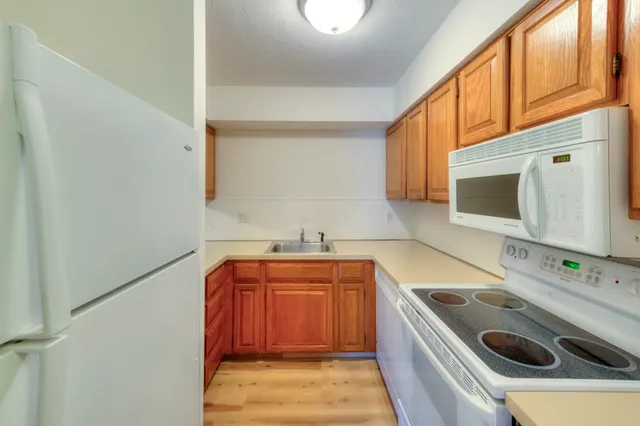 a kitchen with a sink a stove and cabinets