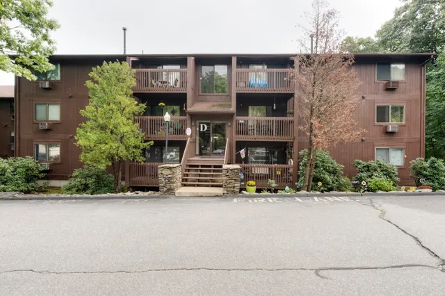 a front view of a building with potted plants