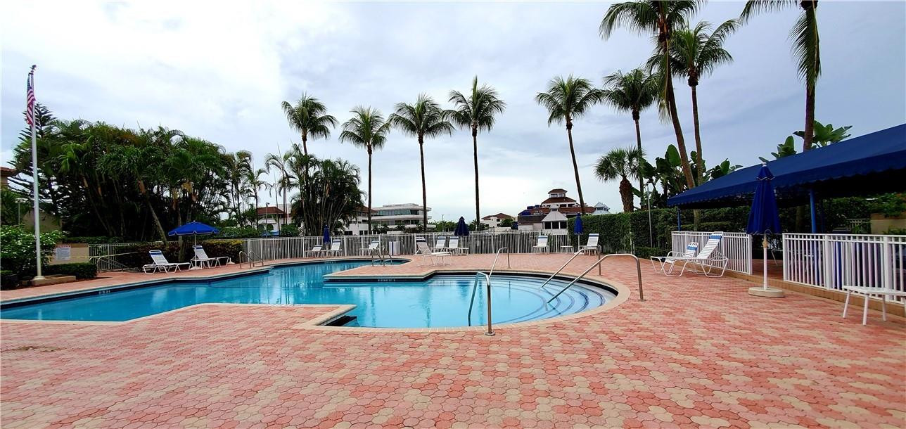 6823 Via Regina Boca Raton, FL 33433 - Photo 25 of 26 a view of a swimming pool with a lounge chair and palm trees