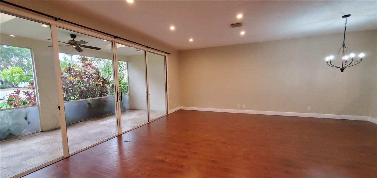 6823 Via Regina Boca Raton, FL 33433 - Photo 8 of 26 a view of an empty room with wooden floor and a window
