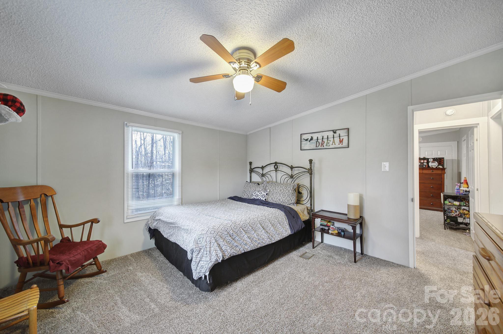 3840 Sherer Road Sharon, SC 29742 - Photo 12 of 30 a bedroom with a bed and a chandelier