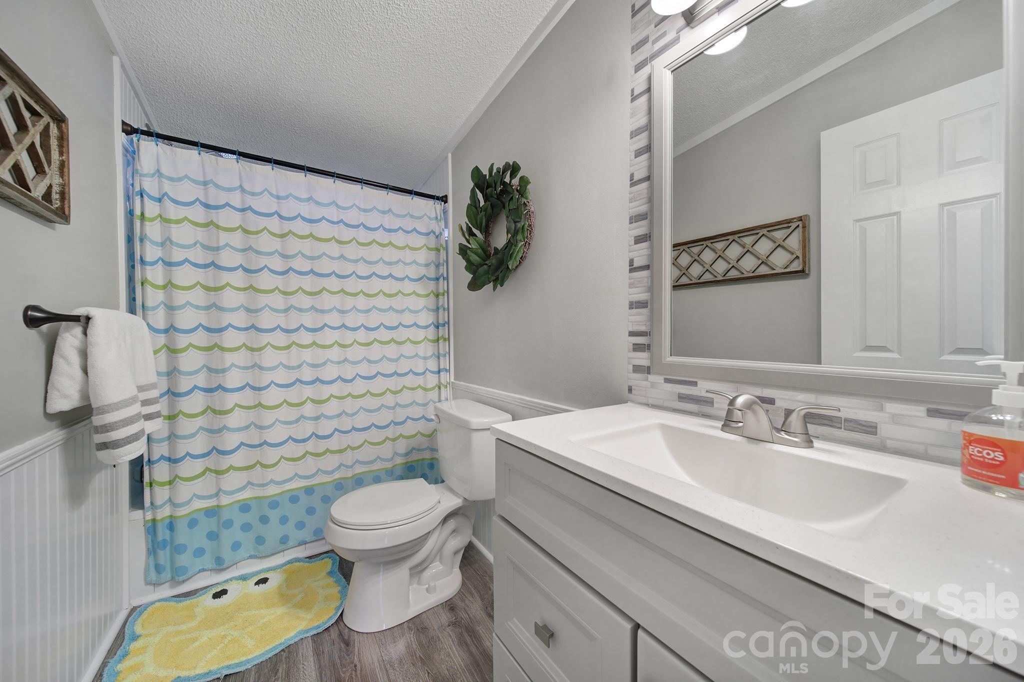 3840 Sherer Road Sharon, SC 29742 - Photo 13 of 30 a bathroom with a granite countertop toilet sink and mirror