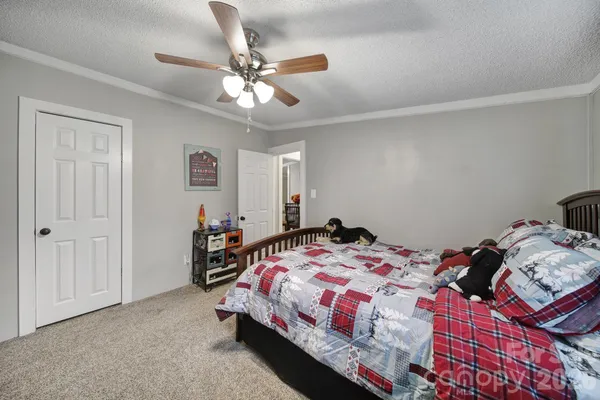a bedroom that has a bed and a chandelier