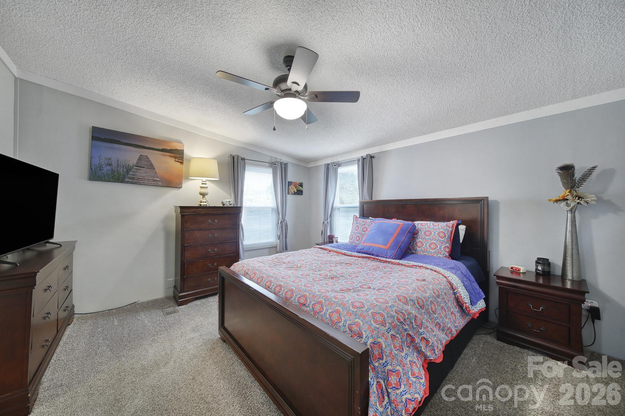 3840 Sherer Road Sharon, SC 29742 - Photo 16 of 30 a bedroom with a bed and a flat screen tv