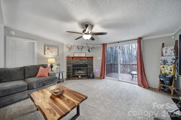a living room with furniture a fireplace and a flat screen tv