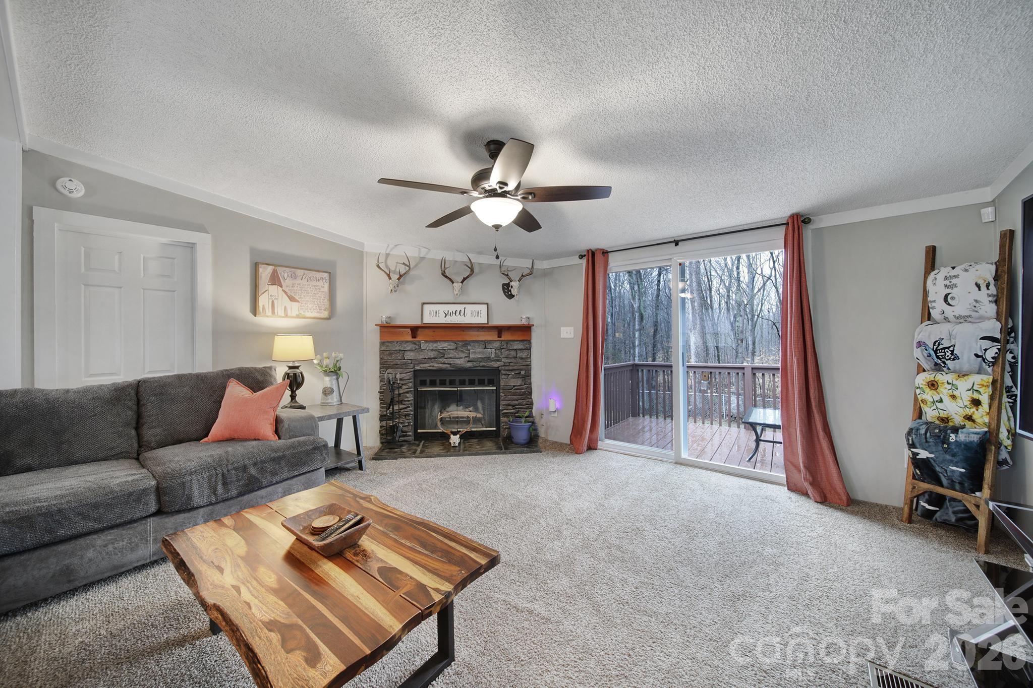 3840 Sherer Road Sharon, SC 29742 - Photo 2 of 30 a living room with furniture a fireplace and a flat screen tv