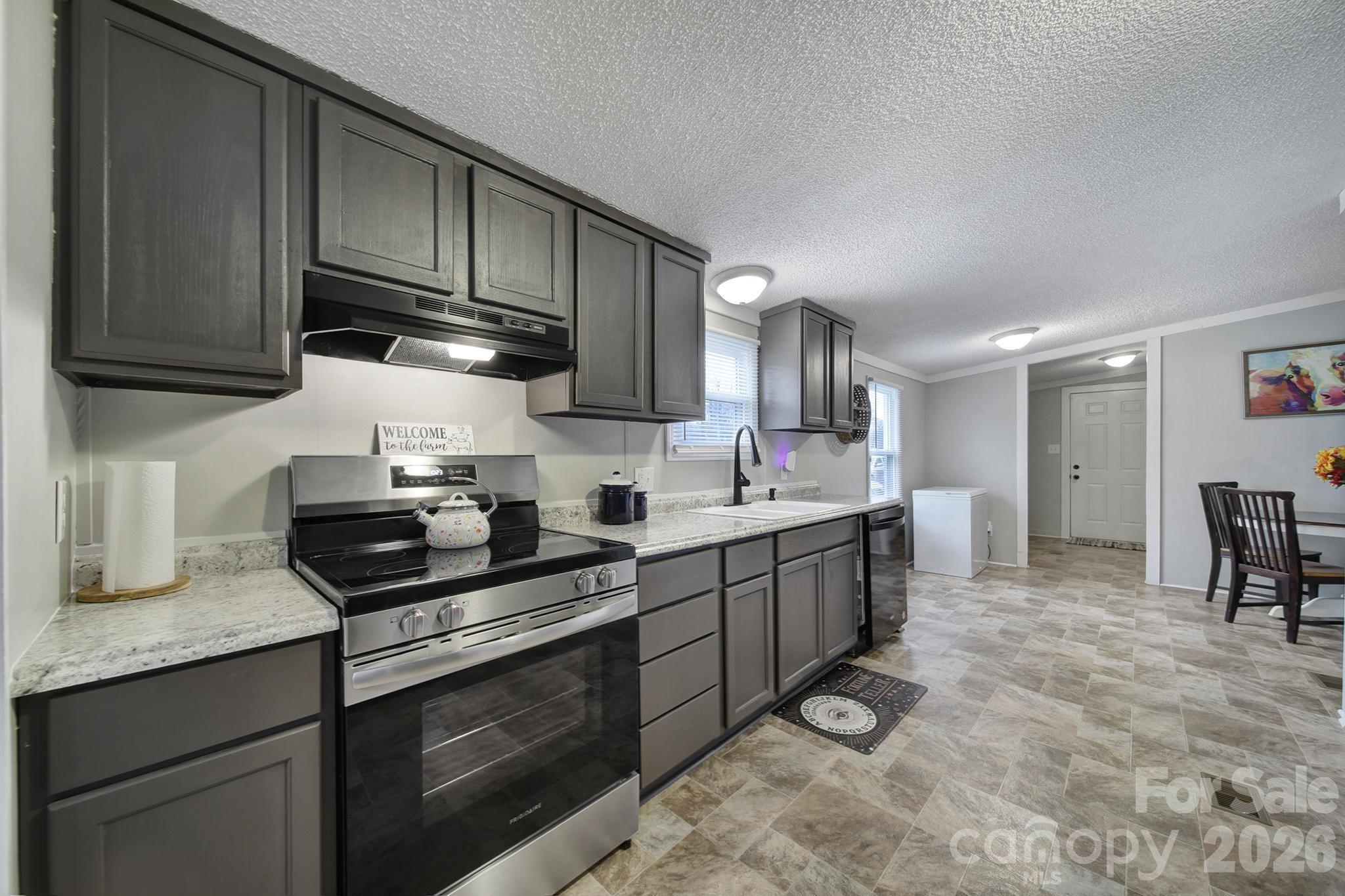 3840 Sherer Road Sharon, SC 29742 - Photo 6 of 30 a kitchen with stainless steel appliances granite countertop a sink stove and cabinets