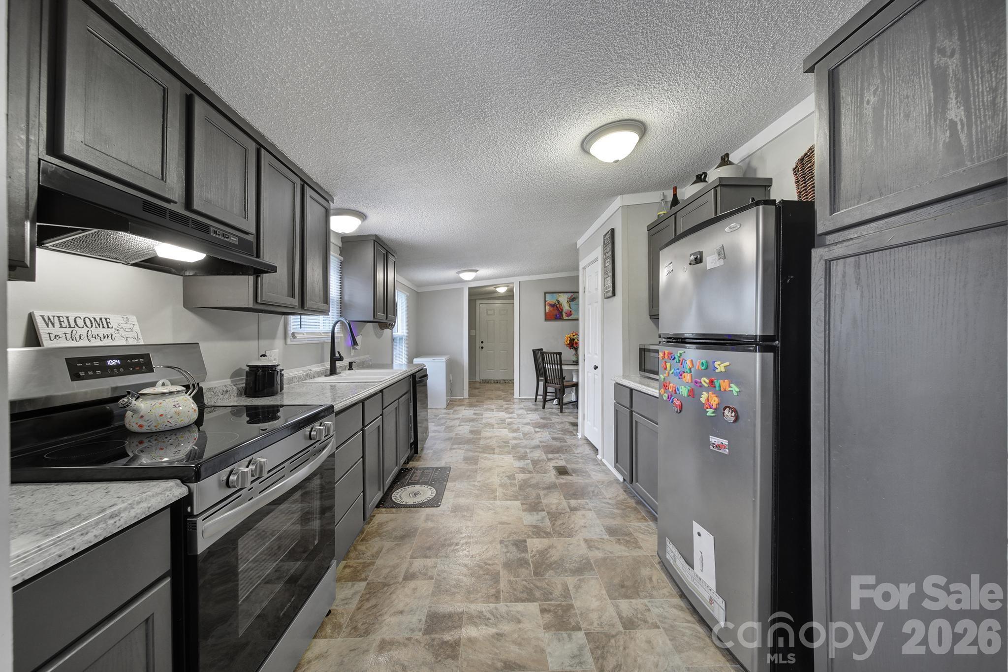3840 Sherer Road Sharon, SC 29742 - Photo 7 of 30 a kitchen with stainless steel appliances granite countertop a refrigerator and a stove