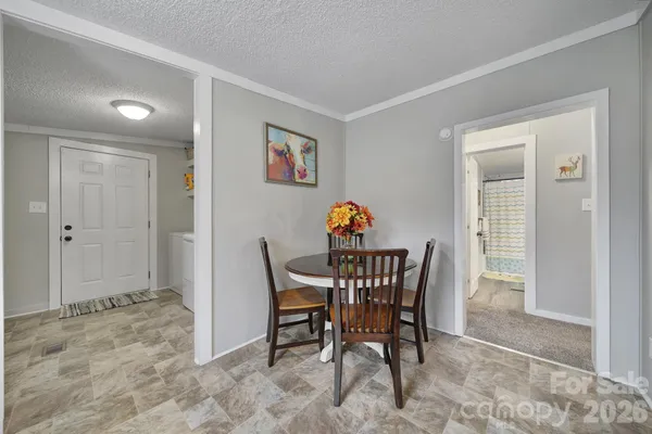 a view of a dining room that has a table and a chair in it