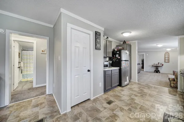 a view of a open kitchen and a sink