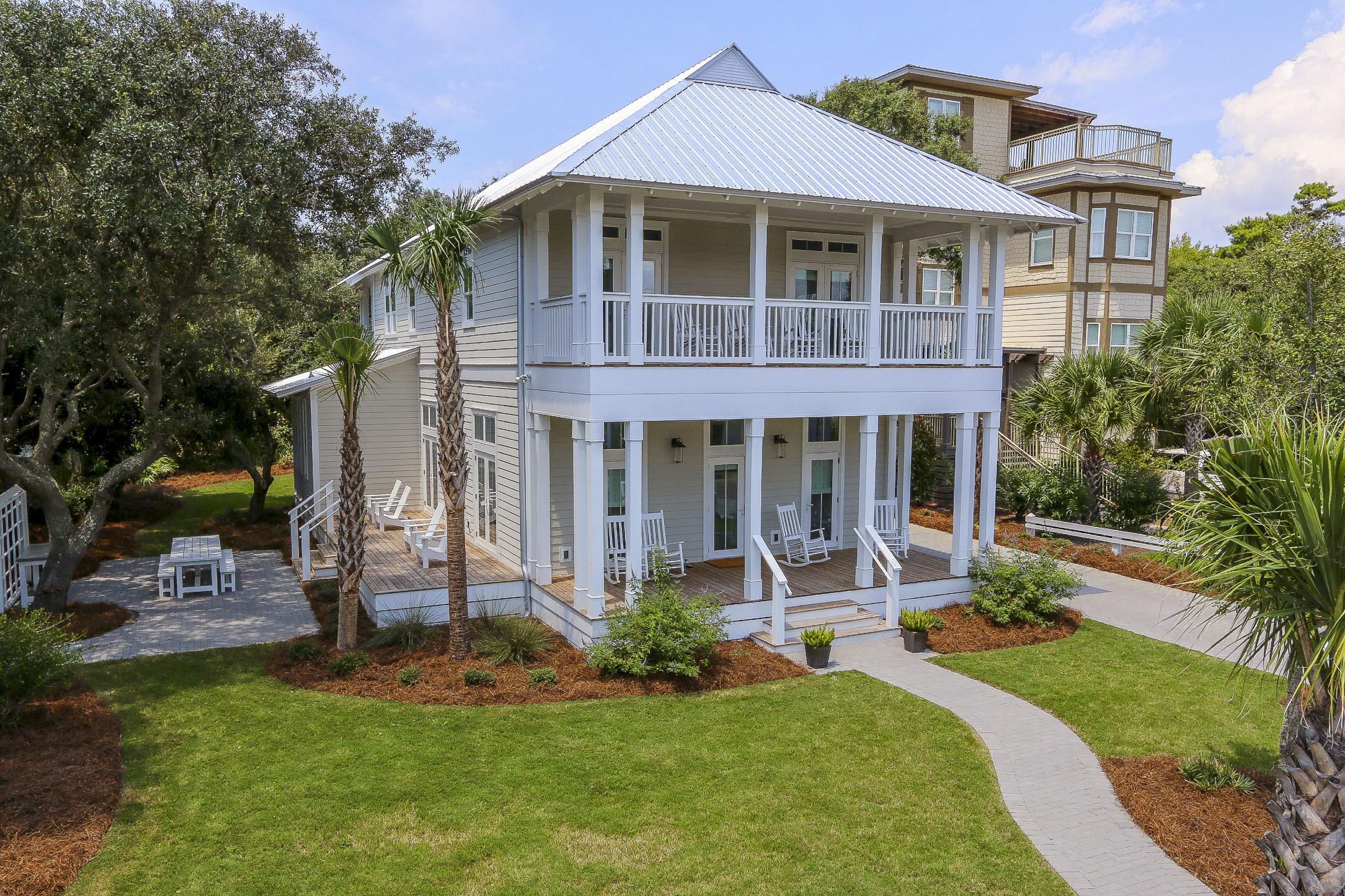 94 Blue Lake Road Santa Rosa Beach, FL 32459 - Photo 1 of 38 a front view of a house with a yard table and chairs
