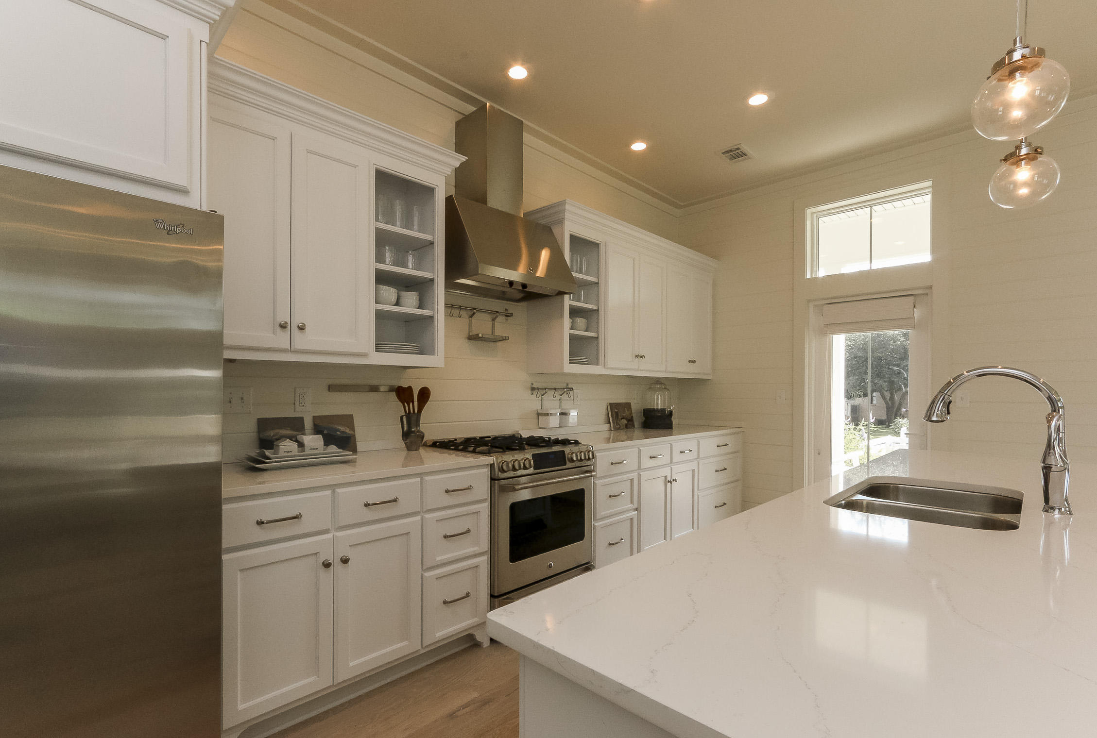 94 Blue Lake Road Santa Rosa Beach, FL 32459 - Photo 16 of 38 a kitchen with white cabinets and appliances