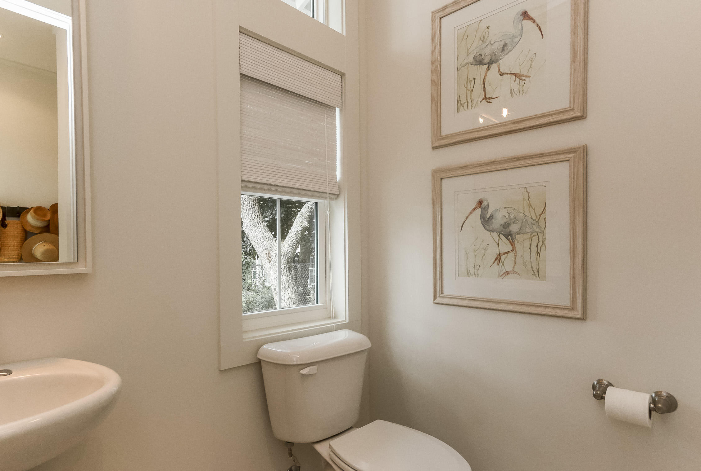 94 Blue Lake Road Santa Rosa Beach, FL 32459 - Photo 19 of 38 a white toilet sitting next to a bathroom sink