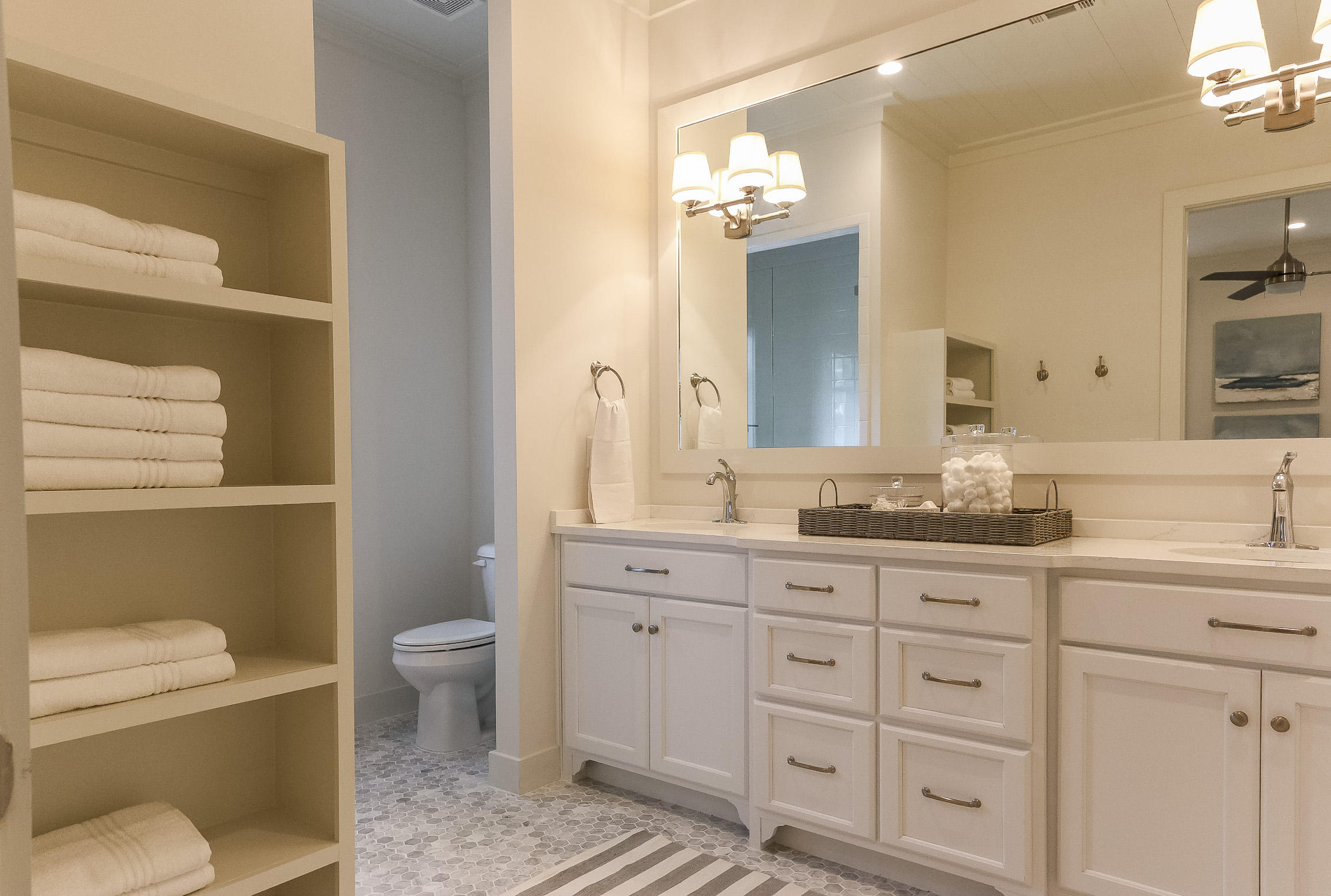 94 Blue Lake Road Santa Rosa Beach, FL 32459 - Photo 22 of 38 a bathroom with a granite countertop toilet sink and mirror